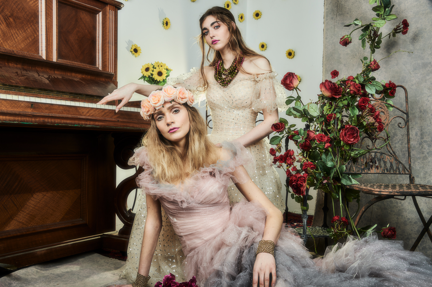 "beautiful hippy styled women in front of piano and roses and sunflowers"