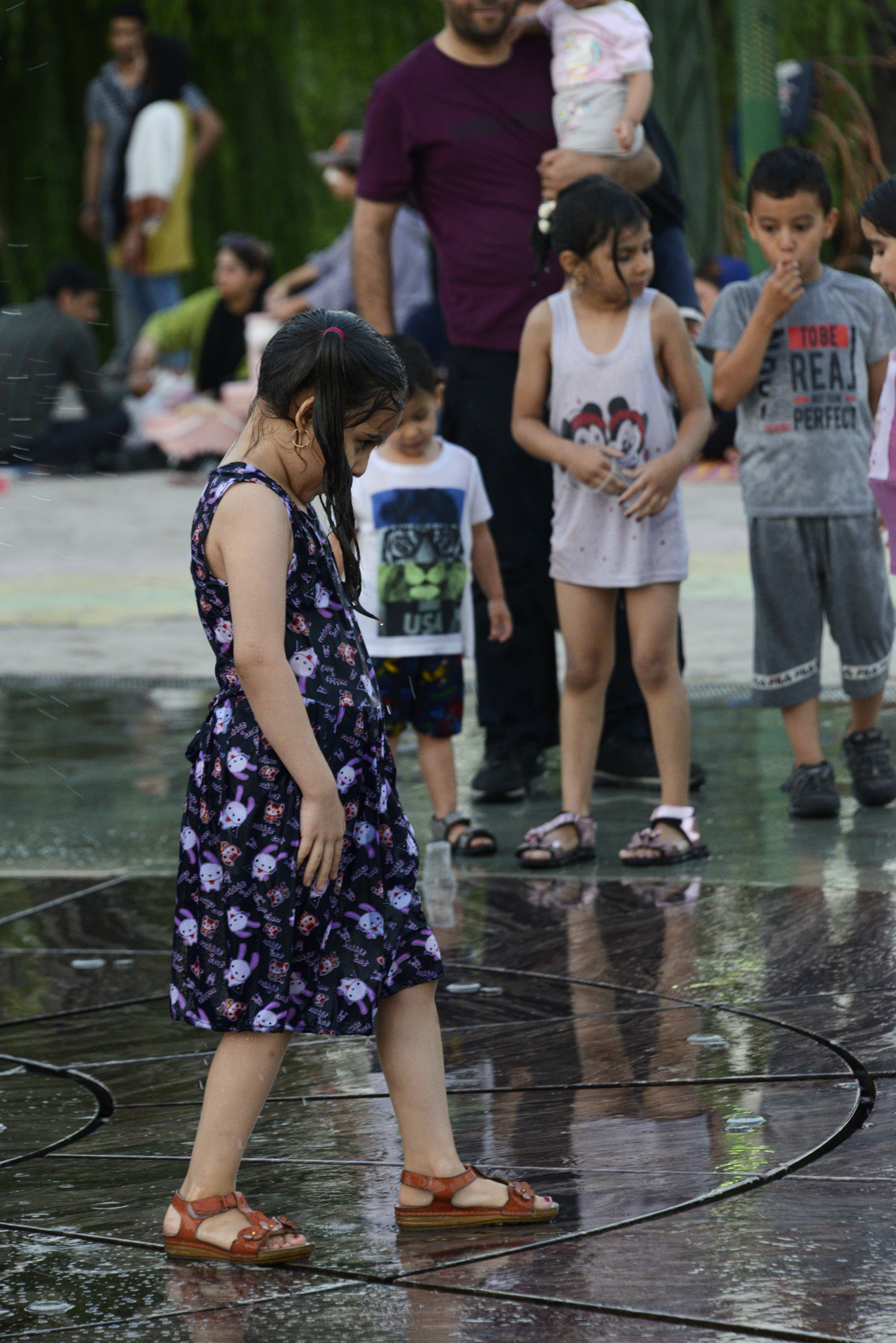 "Ab-o-Atash Park Tehran, Iran people enjoying water fountains"